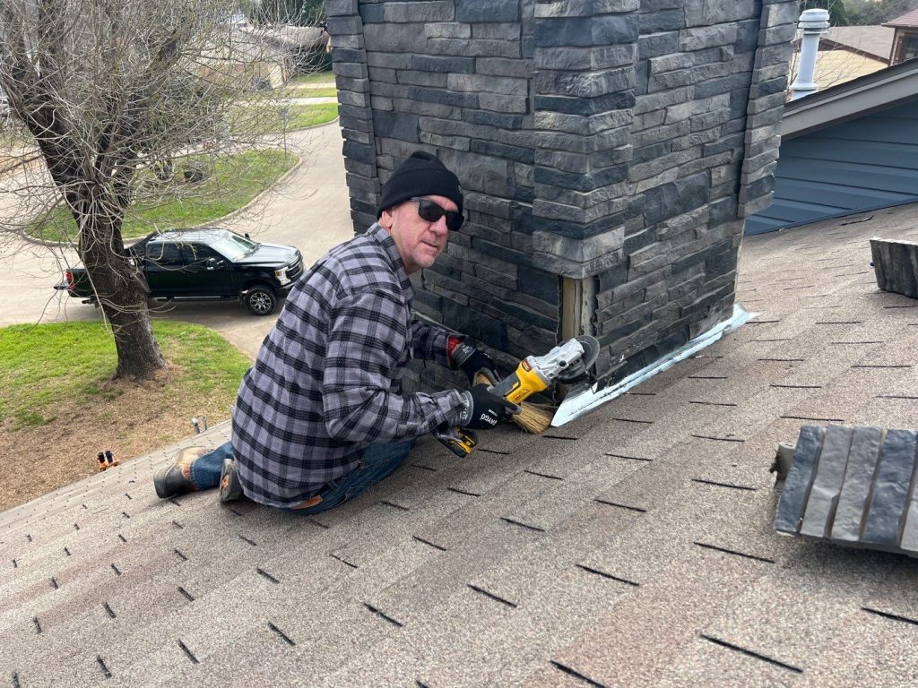 Repairing roofing and chimney damage on a residential roof damaged by hail storms.
